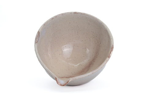 Looking down into the beige Hagi spouted chawan showing the smooth cream-glazed interior - overhead interior view