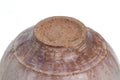 Underside of the beige Hagi spouted matcha bowl showing the exposed clay foot ring and concentric throwing marks