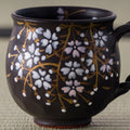Black Weeping Sakura Mug - closeup of the hand-painted weeping cherry blossoms on the front