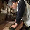 Riichi Yoshida using hand rolling method on tea leaves