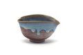 Front view of the drip-glazed katakuchi rotated to show the spout.