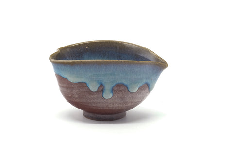 Front view of the drip-glazed katakuchi rotated to show the spout.