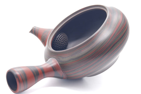 The kyusu with its lid removed, revealing the wide opening and dark interior, lid set beside.