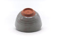 Underside of the bowl showing the reddish clay foot ring and base.