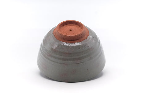 Underside of the bowl showing the reddish clay foot ring and base.
