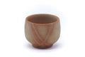 Small Bizen-yaki guinomi teacup in warm beige clay marked with orange hidasuki straw lines, front view on a small foot.