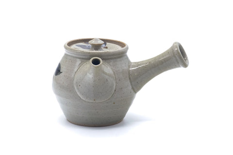 Three-quarter view of the grey kyusu showing the domed lid and knob above the fruit-painted body.