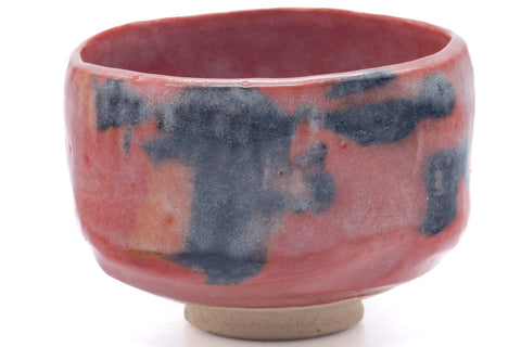 Wider view showing the red glaze with vertical dark blue-grey streaks.