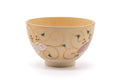 Front view of the ochre chawan showing the scattered painted motifs.