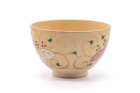 Front view of the ochre chawan showing the scattered painted motifs.
