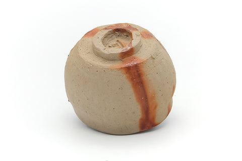Underside of the cup showing the spiral-cut foot and unglazed base.