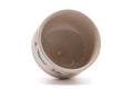 The bowl tilted to reveal the foot and underside.