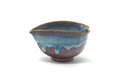 Agano-yaki spouted water cooler (katakuchi) in brown clay with blue drip glaze, shown from the front with its pouring lip.