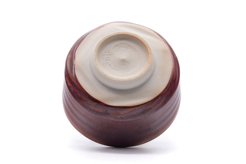Tilted view showing the foot ring and pale clay base.