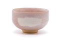 The bowl rotated to show the pink glaze and pale-blue accents.