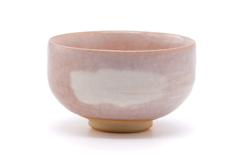 The bowl rotated to show the pink glaze and pale-blue accents.