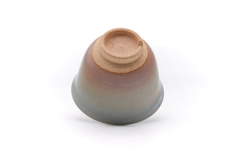 Angled underside showing the foot and the pink-to-grey glaze on the base.