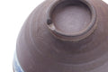 Close-up of the inverted mountainous-band chawan base, showing the foot ring and lower purple body