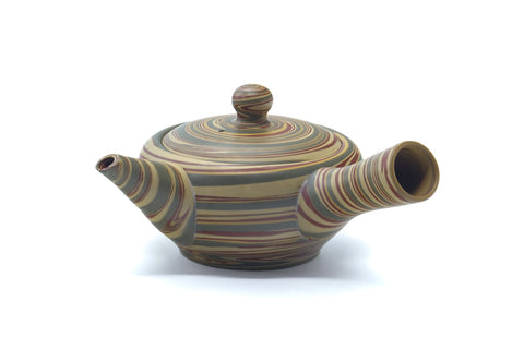 Three-quarter view of the layered nerikomi teapot with lid on.
