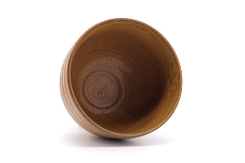 Overhead view into the bowl showing the amber glazed interior and a spiral at the well.
