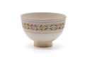 White Kyo-yaki chawan, front view with a colourful shippo interlocking-circle band and gold rim.