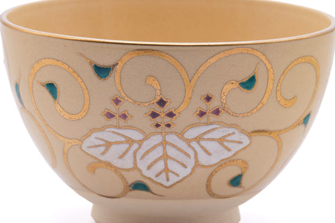 Close-up of a blue-and-purple painted motif on the ochre glaze.