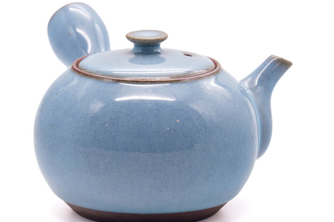 Three-quarter view of the kyusu highlighting the spout and pale blue body.