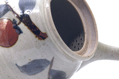 Close-up of the rim and interior with the lid off, the side handle at left.