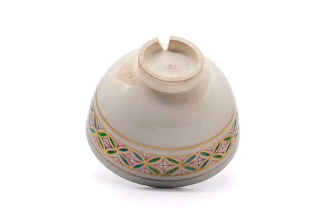 Underside of the chawan with the patterned band wrapping toward the foot.
