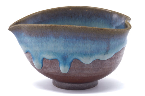 Larger front view highlighting the blue glaze dripping over the brown body.