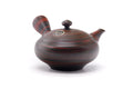 Side-handled Tokoname-yaki kyusu teapot in dark marbled clay, shown from a three-quarter angle with its lid knob and spout.
