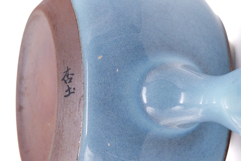 Underside of the kyusu showing the handle attachment and foot.