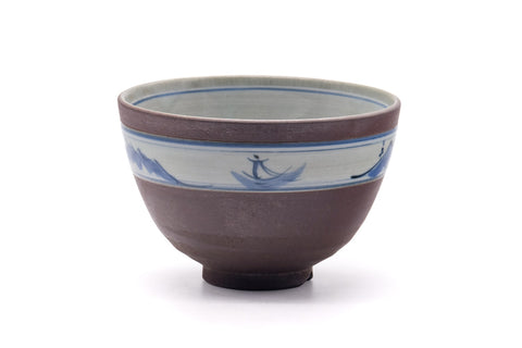 Mountainous-band chawan, front view showing the muted purple body and blue landscape motif near the rim