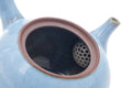 Closeup into the open mouth showing the integrated ceramic strainer.