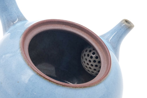 Closeup into the open mouth showing the integrated ceramic strainer.