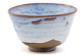 Three-quarter view emphasising the milky blue glaze and brown drip down the body.