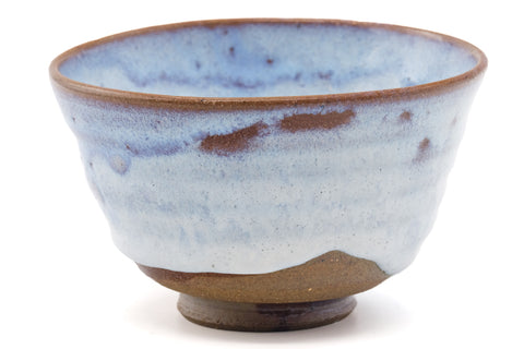 Three-quarter view emphasising the milky blue glaze and brown drip down the body.