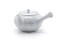 Opposite three-quarter view of the porcelain teapot with the side handle to the right.