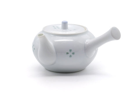 Opposite three-quarter view of the porcelain teapot with the side handle to the right.