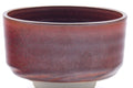 Side view showing the half-cylinder profile and shiny maroon glaze.