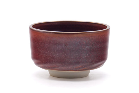 Front view showing the deep maroon glaze with lighter speckles and straight-sided form.