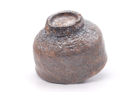 Underside of the bowl showing the foot ring with finger marks and exposed clay.