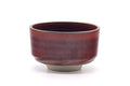 Half-cylinder hantsutsu-gata chawan with a glossy speckled maroon glaze and flat lip, front view.