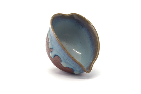 Overhead view into the vessel showing the blue glazed interior and pouring lip.