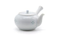 White porcelain Arita kyusu teapot with side handle and spout, three-quarter view, subtle floral relief pattern.