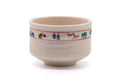 Cream Akahada-yaki matcha bowl with a colourful painted band near the rim, front view.