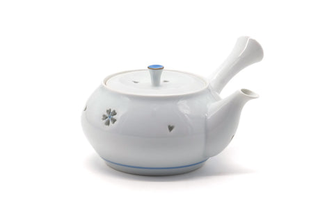The teapot with the spout to the right and the side handle to the left.