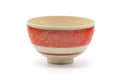 Front view of the wan-nari Kyo-yaki chawan with gold momiji maple leaves over a red band