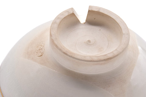Underside closeup of the chawan showing the foot ring and a small maker's mark.