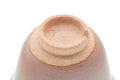 Inverted view showing the unglazed foot ring and the pink-blushed base.